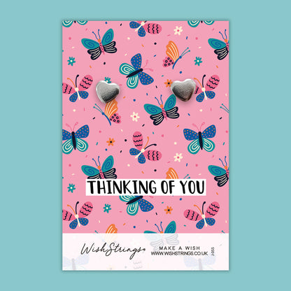 a pink card with butterflies on it