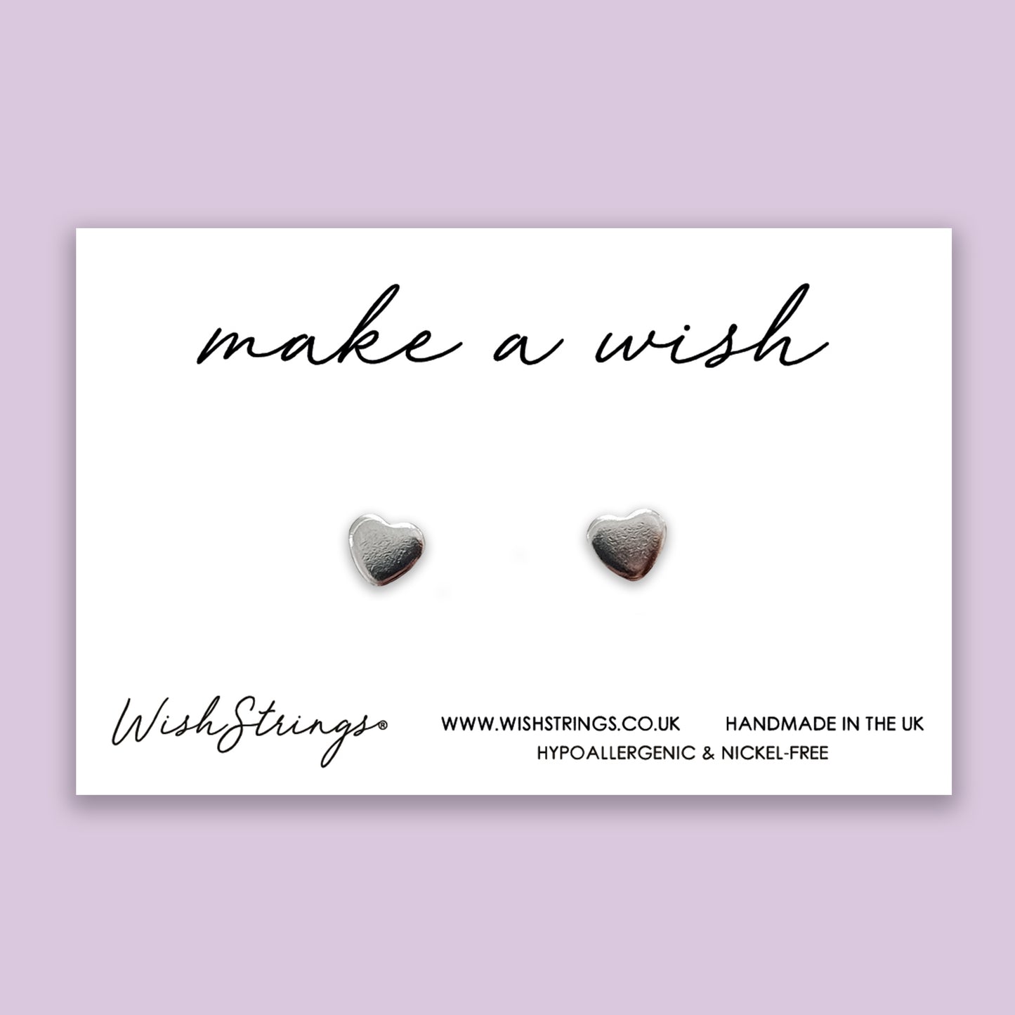 a pair of heart shaped earrings with the words make a wish