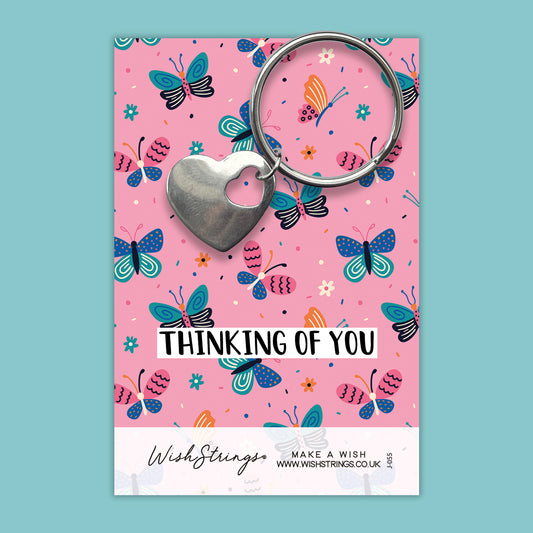 a card with a heart shaped keychain on it